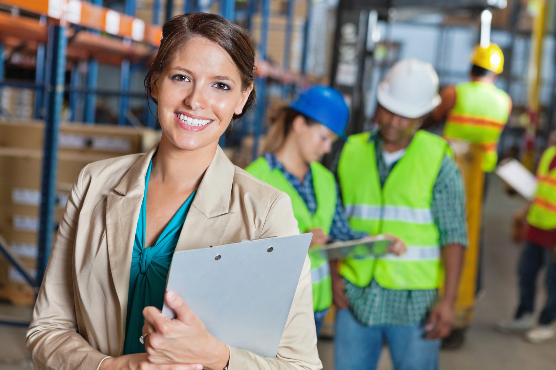 Happy manager in shipping and distribution warehouse facility
